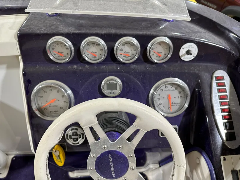 Slide: The Image of Dashboard of a 2005 Eliminator 260 Eagle XP boat with gauges and steering wheel. - 18