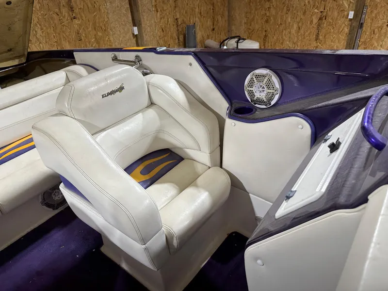 Slide: The Image of 2005 Eliminator 260 Eagle XP boat interior with white and purple seating. - 20