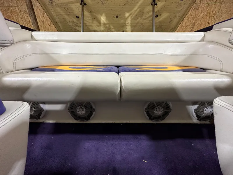 Slide: The Image of 2005 Eliminator 260 Eagle XP boat interior with white seating and built-in speakers. - 22