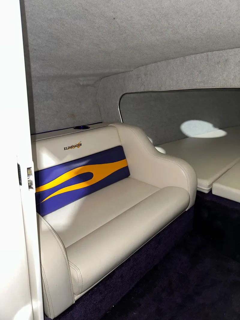 Slide: The Image of 2005 Eliminator 260 Eagle XP interior with white and blue seating. - 26