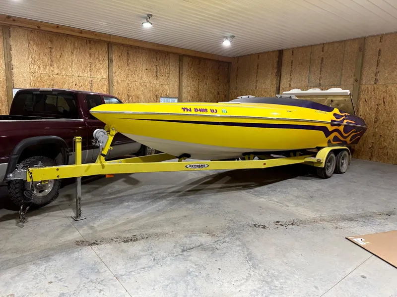 Slide: The Image of Yellow 2005 Eliminator 260 Eagle XP boat on trailer in garage. - 3