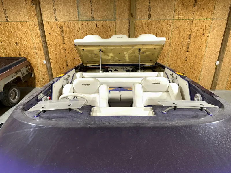 Slide: The Image of 2005 Eliminator 260 Eagle XP boat with open engine hatch in a garage setting. - 33