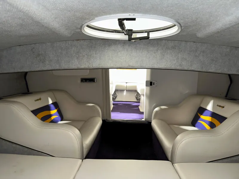 Slide: The Image of Interior of a 2005 Eliminator 260 Eagle XP boat with plush seating and modern design. - 34