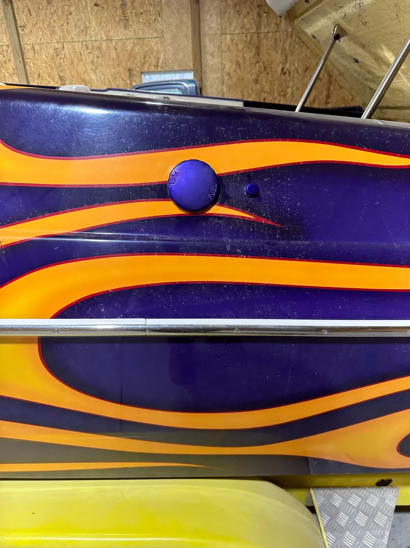 Slide: The Image of 2005 Eliminator 260 Eagle XP with vibrant orange and purple flame design. - 36