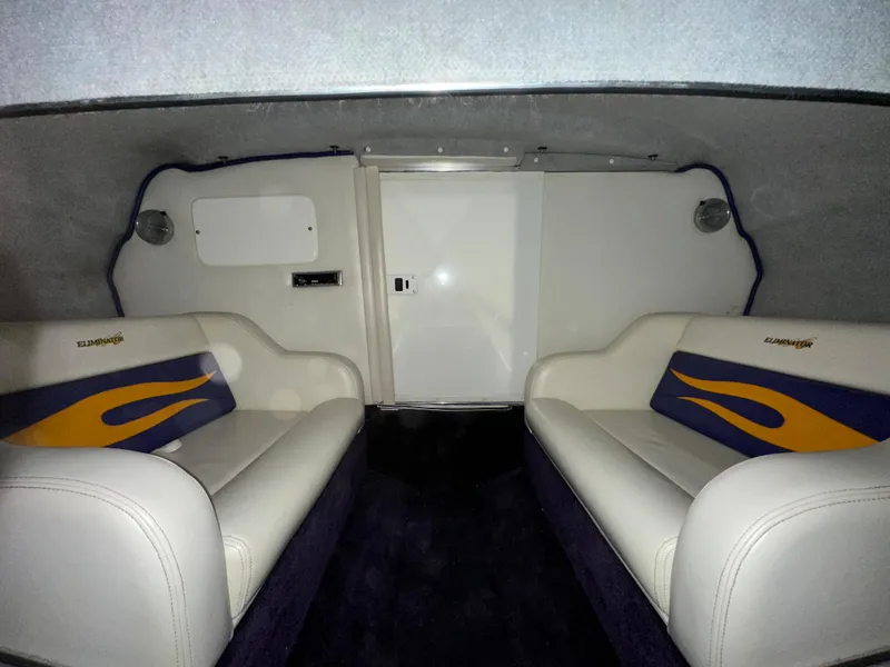 Slide: The Image of Interior of a 2005 Eliminator 260 Eagle XP boat with white seating and blue accents. - 37