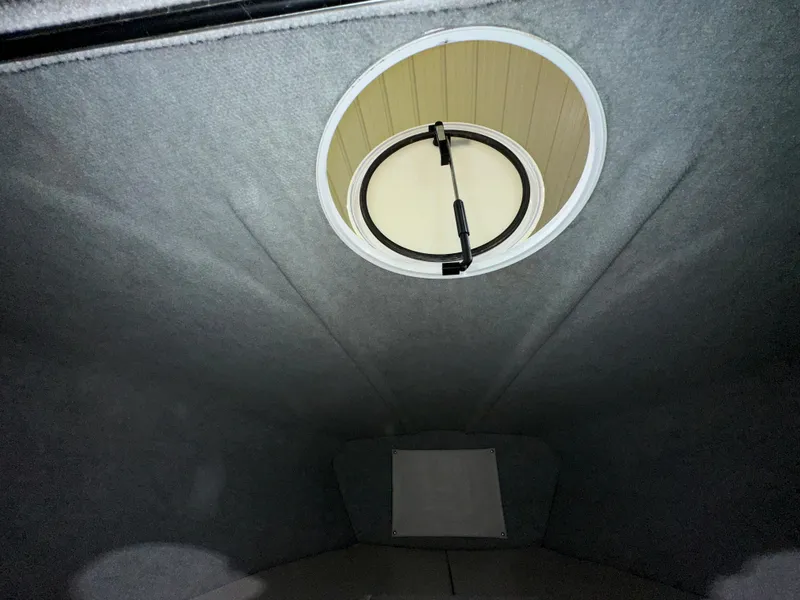 Slide: The Image of Interior view of a 2005 Eliminator 260 Eagle XP boat cabin with circular hatch. - 41
