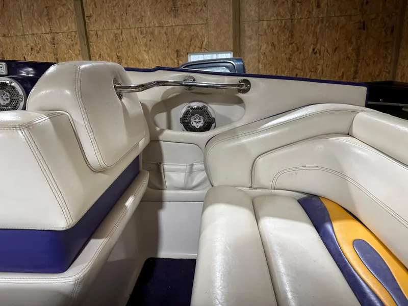 Slide: The Image of 2005 Eliminator 260 Eagle XP boat interior with white and blue seating. - 42