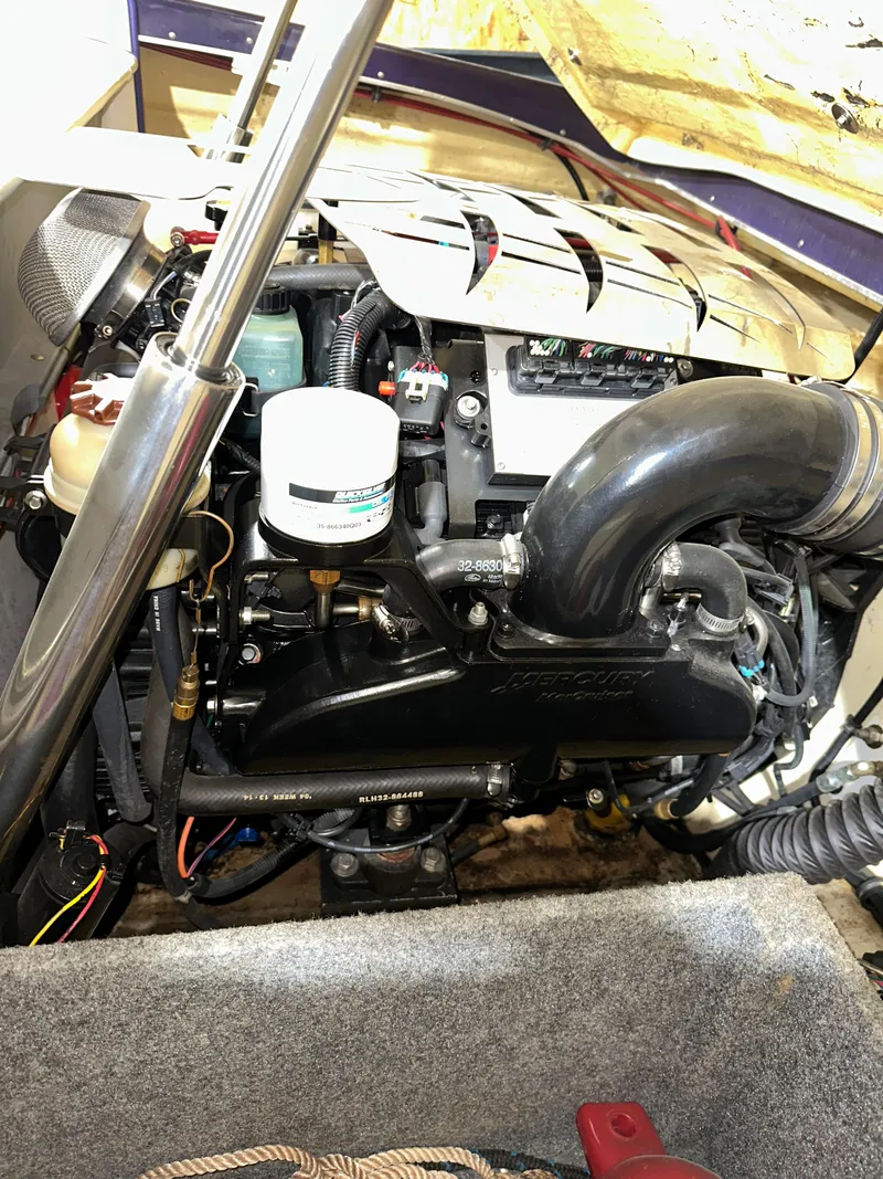 Slide: The Image of Engine compartment of a 2005 Eliminator 260 Eagle XP boat, showcasing detailed components. - 47