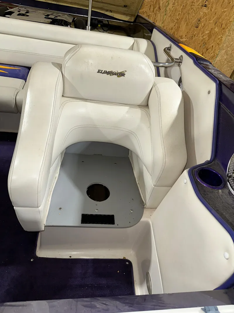 Slide: The Image of 2005 Eliminator 260 Eagle XP boat interior with white seating and purple accents. - 48