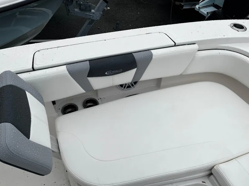 Slide: The Image of 2024 Robalo 266 Cayman boat interior seating with white and gray upholstery. - 15