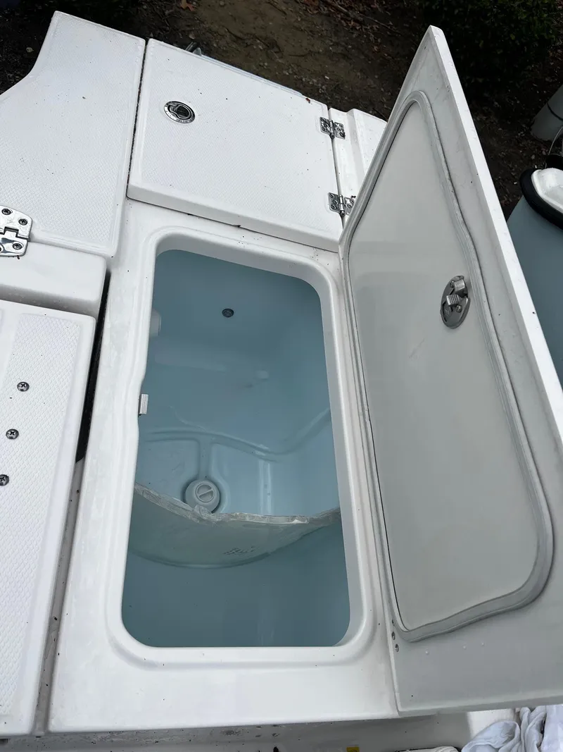 Slide: The Image of 2024 Robalo 266 Cayman open storage compartment. - 8