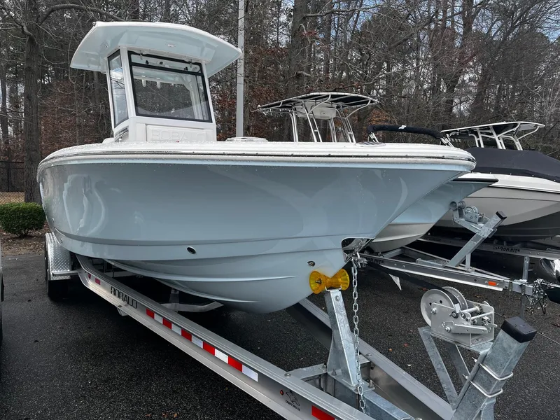 The Image of 2024 Robalo 266 Cayman boat on a trailer in a parking lot. - 1