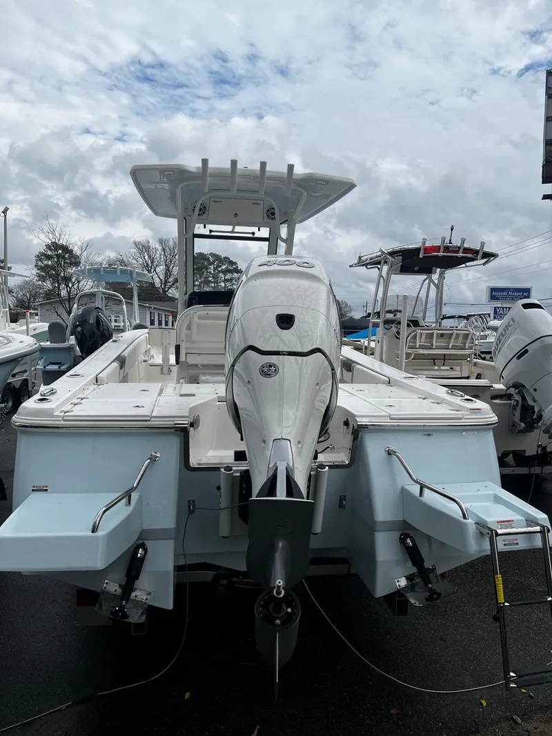 Slide: The Image of 2024 Robalo 266 Cayman boat, rear view, displayed at a marina. - 3