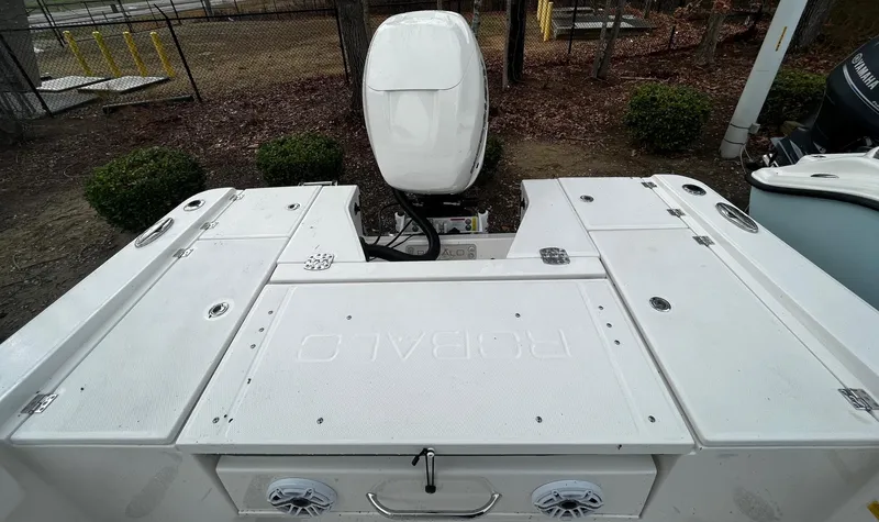 Slide: The Image of 2024 Robalo 266 Cayman boat stern with outboard motor and storage compartments. - 7