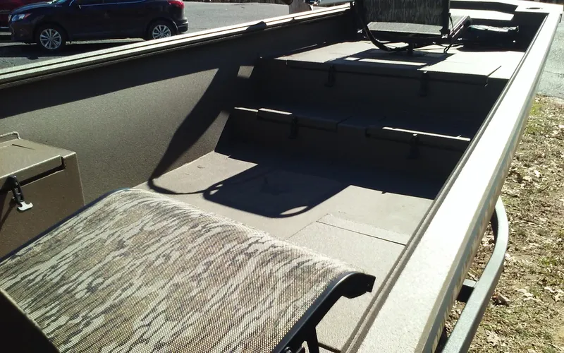 Slide: The Image of 2023 Thor Lake Hammer Elite boat interior with camo seats and storage compartments. - 13