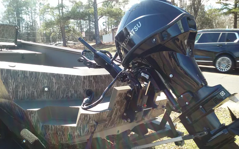 Slide: The Image of 2023 Thor Lake Hammer Elite boat with Tohatsu outboard motor in a wooded area. - 19