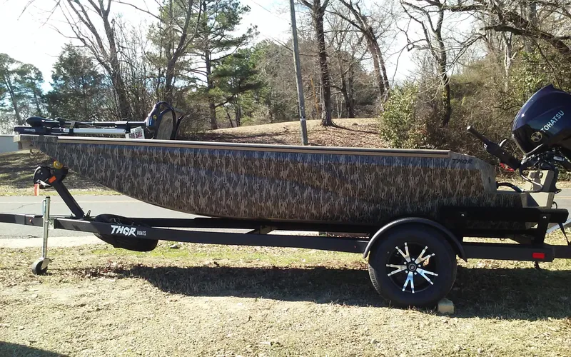 Slide: The Image of 2023 Thor Lake Hammer Elite boat on trailer in outdoor setting. - 21
