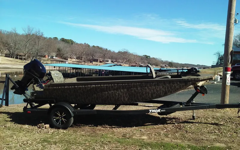 Slide: The Image of 2023 Thor Lake Hammer Elite boat on trailer by lakeside. - 7