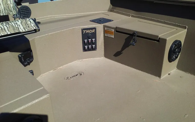 Slide: The Image of 2023 Thor Lake Hammer Elite boat interior with control panel and storage compartment. - 9