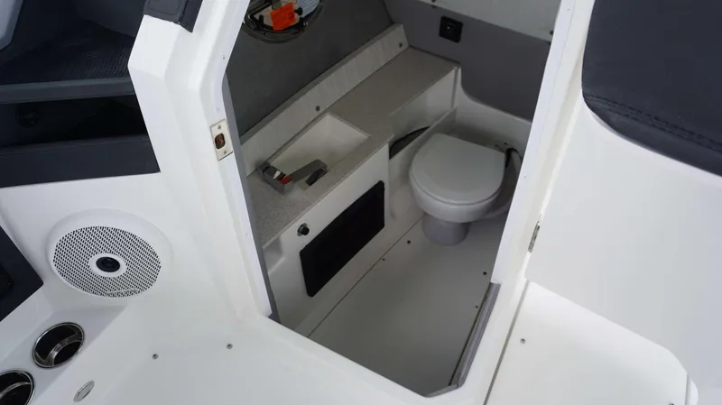 Slide: The Image of 2023 Cobalt R8 boat interior with compact bathroom and modern amenities. - 12