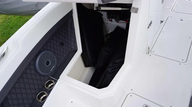 Slide: The Image of 2023 Cobalt R8 boat interior storage compartment with speaker and cup holders. - 14