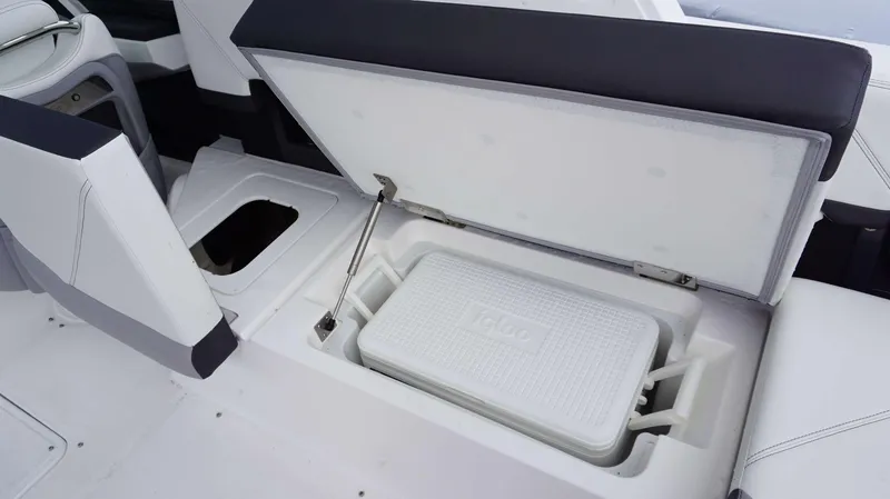 Slide: The Image of 2023 Cobalt R8 boat with open storage compartment and cooler. - 18