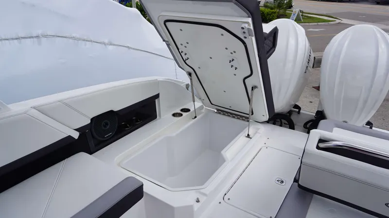 Slide: The Image of 2023 Cobalt R8 boat with open storage compartment and dual outboard engines. - 20