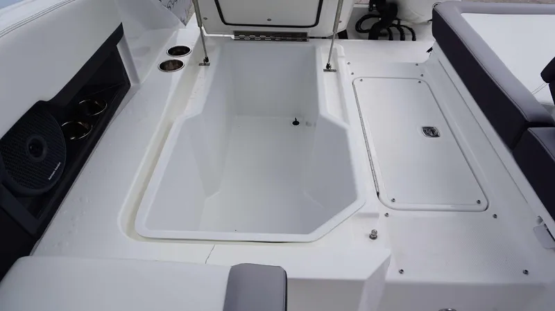 Slide: The Image of 2023 Cobalt R8 boat interior with storage compartment and seating area. - 21