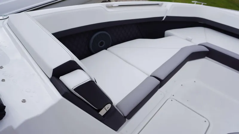Slide: The Image of 2023 Cobalt R8 boat interior with white cushioned seating and speaker. - 25
