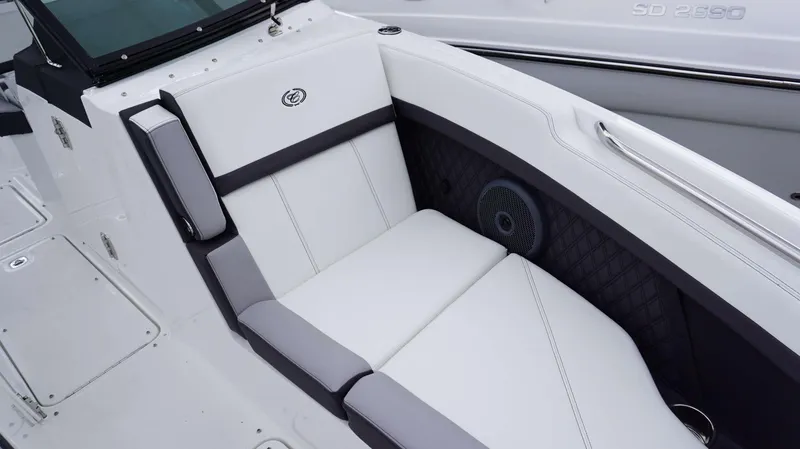 Slide: The Image of 2023 Cobalt R8 boat interior with white cushioned seating and speaker detail. - 26