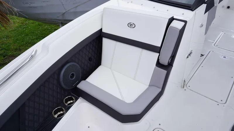 Slide: The Image of 2023 Cobalt R8 boat interior with white cushioned seating and built-in cup holders. - 27