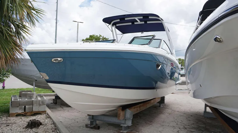 Slide: The Image of 2023 Cobalt R8 boat in blue and white, displayed outdoors on a stand. - 4
