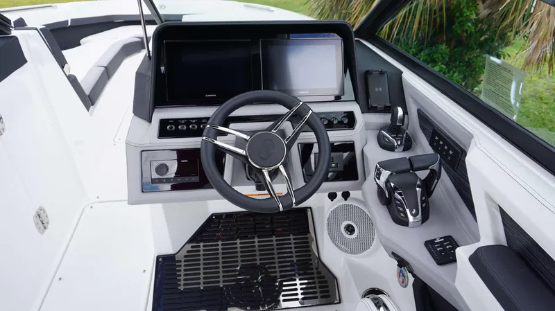 Slide: The Image of 2023 Cobalt R8 boat cockpit with modern steering wheel and navigation displays. - 9
