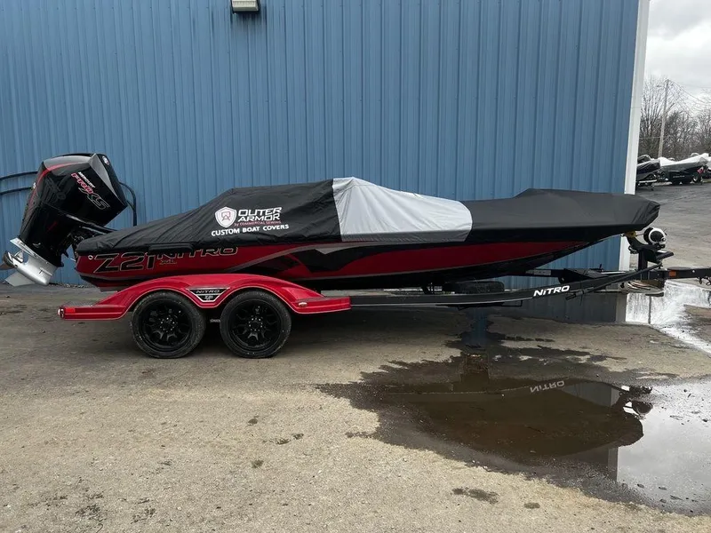Slide: The Image of 2023 Nitro Z21 XL Pro boat with custom cover on trailer. - 8