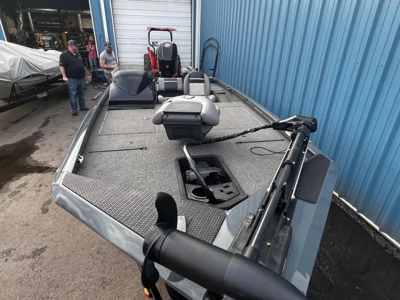 Slide: The Image of 2020 Triton 18 TX fishing boat at a dock with people in the background. - 10