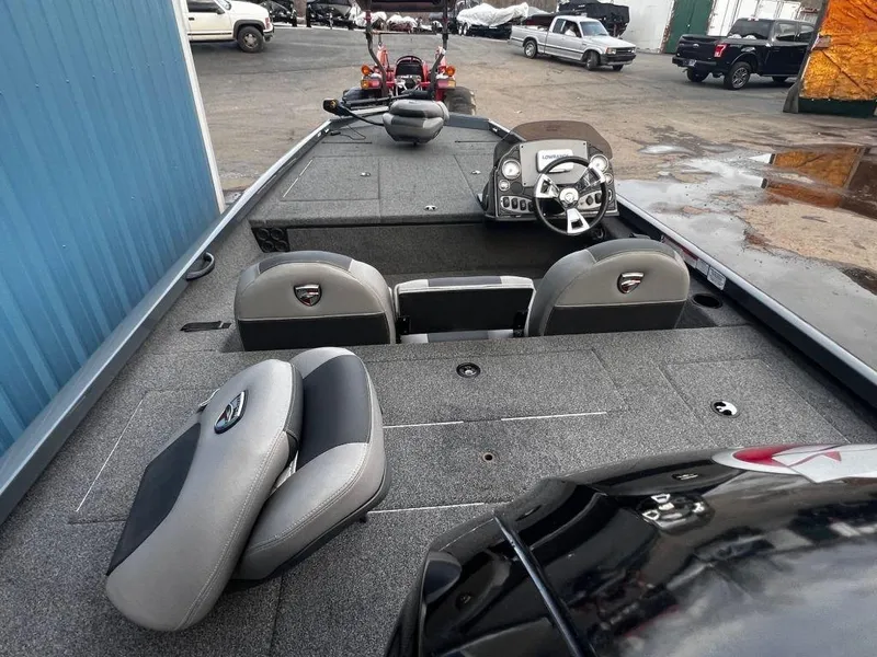 Slide: The Image of 2020 Triton 18 TX fishing boat interior with steering console and seating. - 11