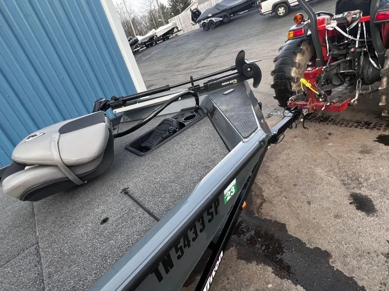 Slide: The Image of 2020 Triton 18 TX boat hitched to a red tractor. - 5