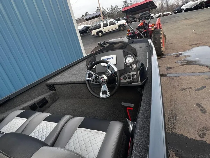 Slide: The Image of 2020 Triton 18 TX boat interior with steering wheel and seats. - 6