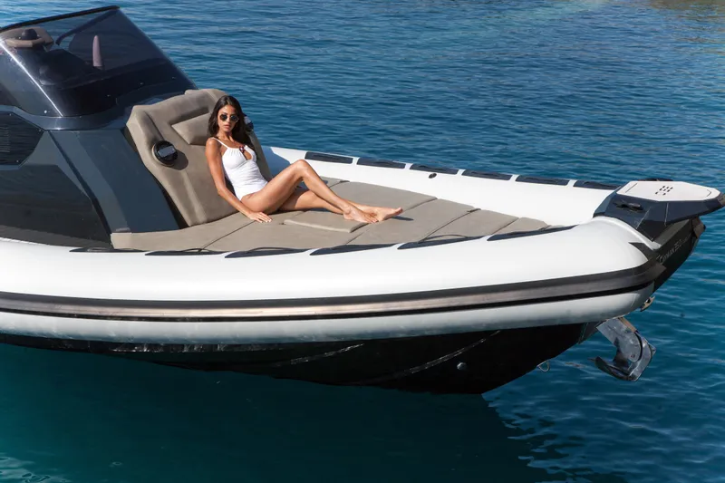 Slide: The Image of Woman relaxing on a 2025 Ranieri CAYMAN 35.0 EXECUTIVE boat in clear blue water. - 7