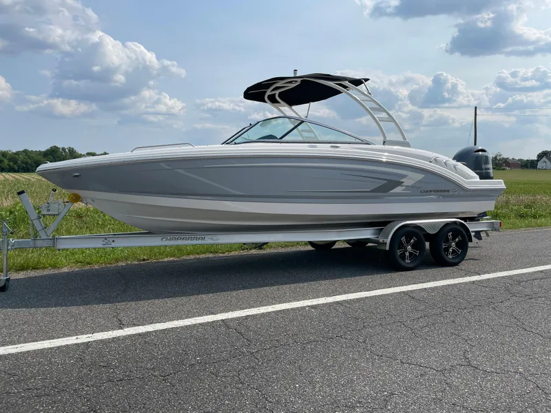 Slide: The Image of 2024 Chaparral 23 SSi OB boat on a trailer, side view, outdoors. - 1