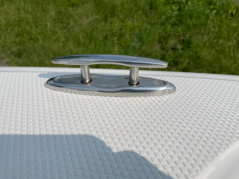 Slide: The Image of 2024 Chaparral 23 SSi OB boat cleat on textured deck. - 12