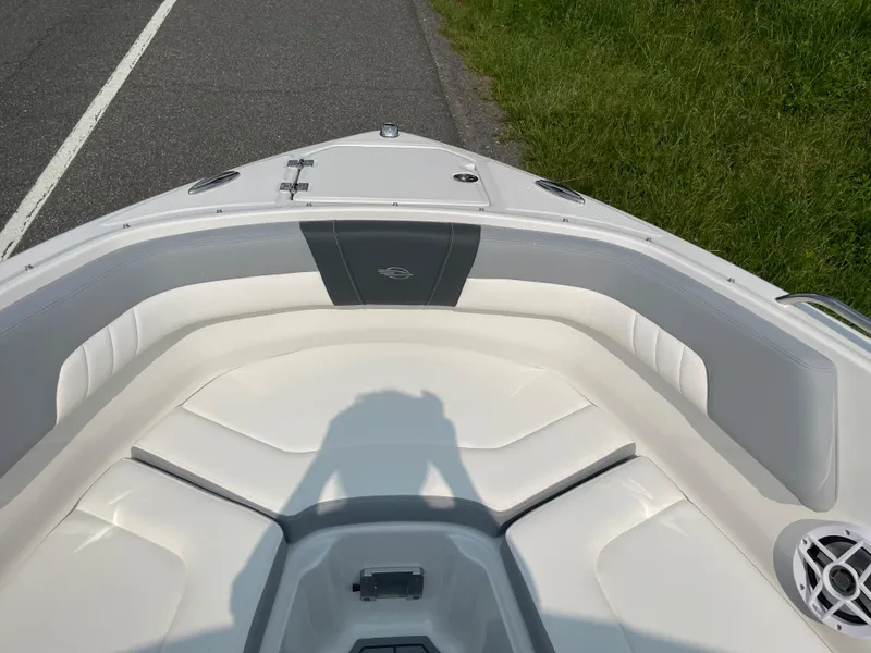 Slide: The Image of 2024 Chaparral 23 SSi OB boat bow seating area with white and gray upholstery. - 13