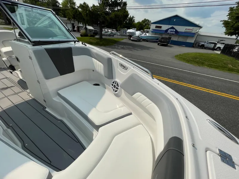 Slide: The Image of 2024 Chaparral 23 SSi OB boat interior with white and gray seating. - 16