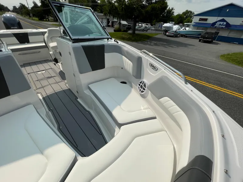 Slide: The Image of 2024 Chaparral 23 SSi OB boat interior with white and gray seating. - 17