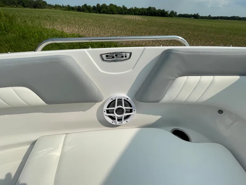 Slide: The Image of 2024 Chaparral 23 SSi OB boat interior with white and gray seating. - 19