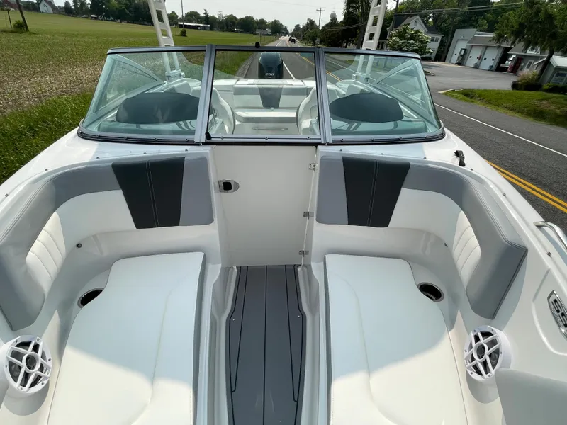 Slide: The Image of 2024 Chaparral 23 SSi OB boat interior with white and gray seating. - 21