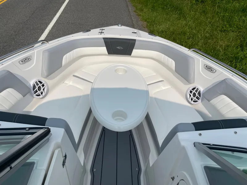 Slide: The Image of 2024 Chaparral 23 SSi OB boat interior with white seating and round table. - 23