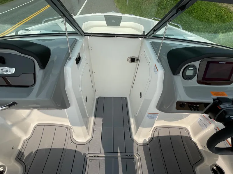 Slide: The Image of 2024 Chaparral 23 SSi OB boat interior, featuring helm and passenger seating. - 24