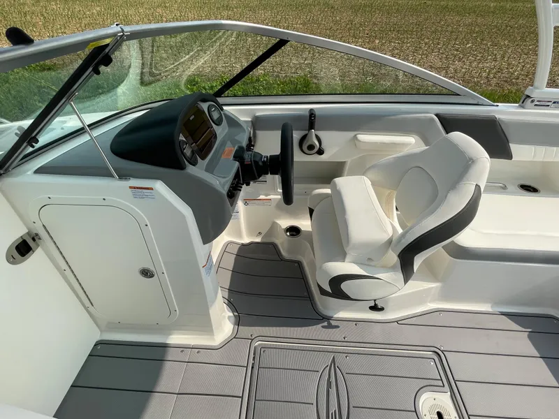 Slide: The Image of 2024 Chaparral 23 SSi OB boat interior with helm and seating. - 29