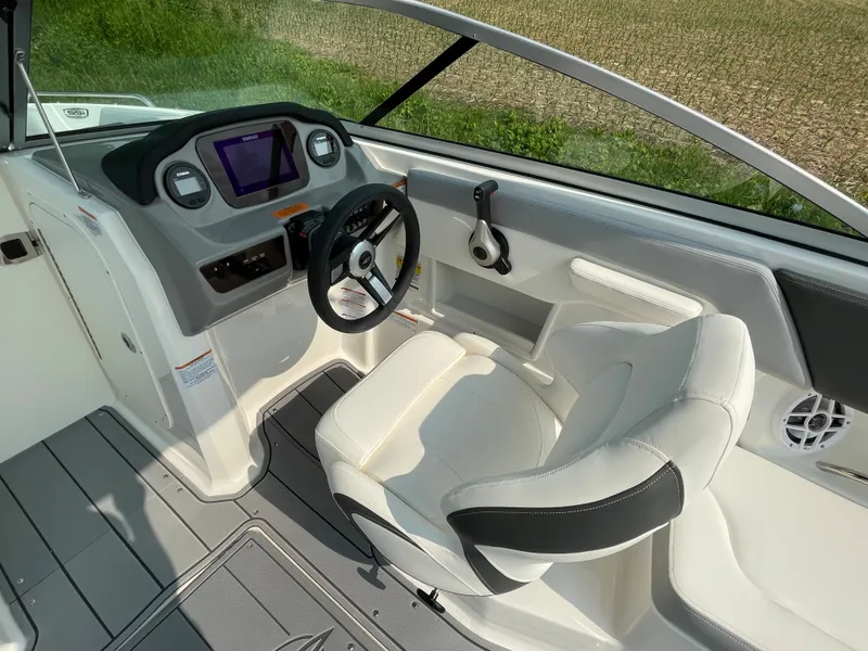 Slide: The Image of 2024 Chaparral 23 SSi OB boat cockpit with steering wheel and dashboard. - 31